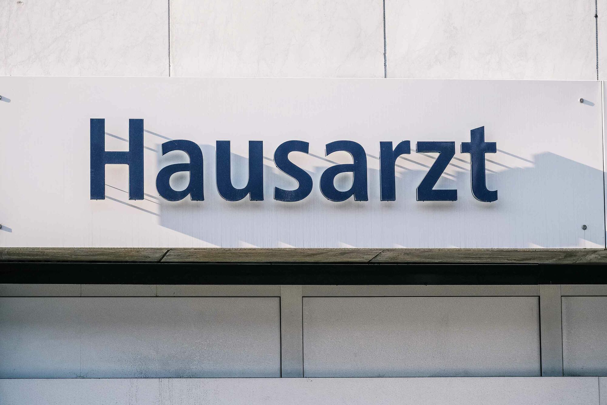 Das Foto zeigt eine Schild mit der Aufschrift "Hausarzt".